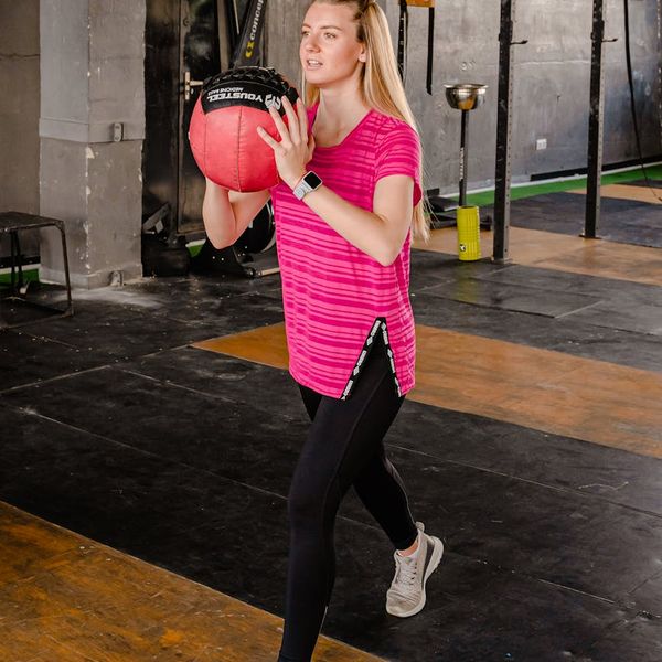 Woman performing a dynamic yoga pose, radiating energy and strength.